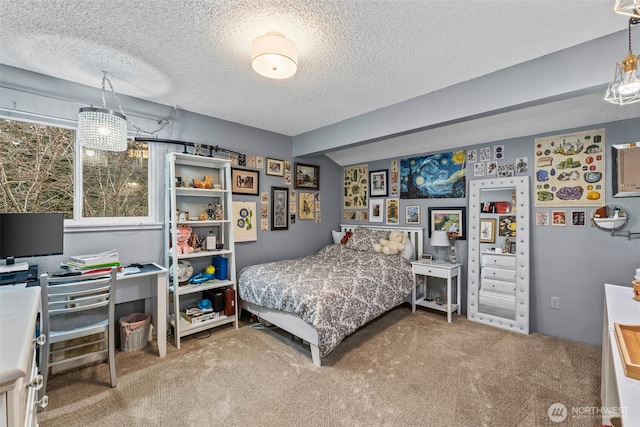 bedroom with carpet floors and a textured ceiling