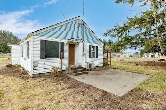 view of front of property featuring a patio and ac unit