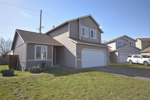 traditional-style house featuring an attached garage, driveway, a front yard, and fence