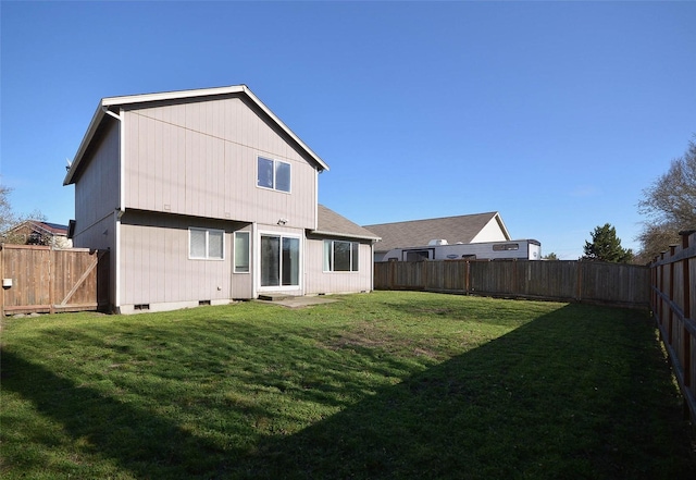 back of property featuring crawl space, a lawn, and a fenced backyard