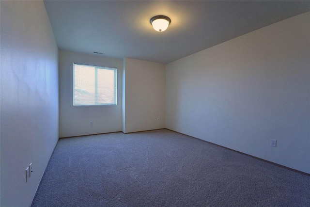 unfurnished room featuring light carpet