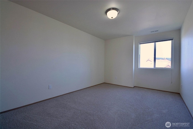 unfurnished room featuring light carpet, visible vents, and baseboards