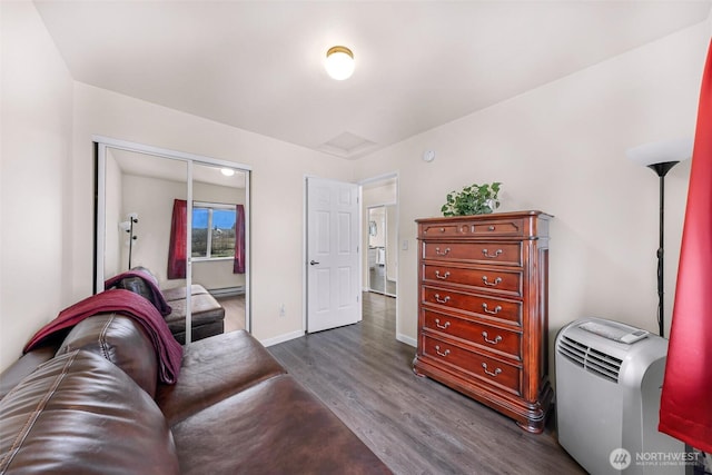 living room featuring a baseboard radiator, dark wood finished floors, and baseboards