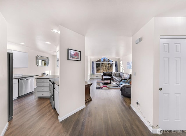 hall featuring dark wood-style floors, baseboards, and a wealth of natural light