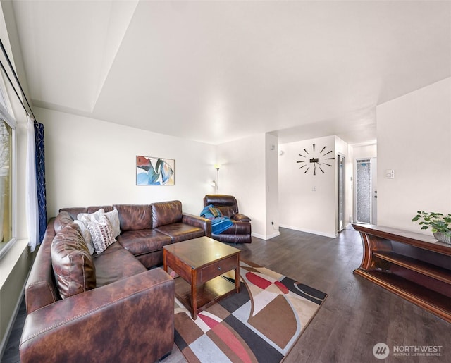 living area with baseboards and wood finished floors