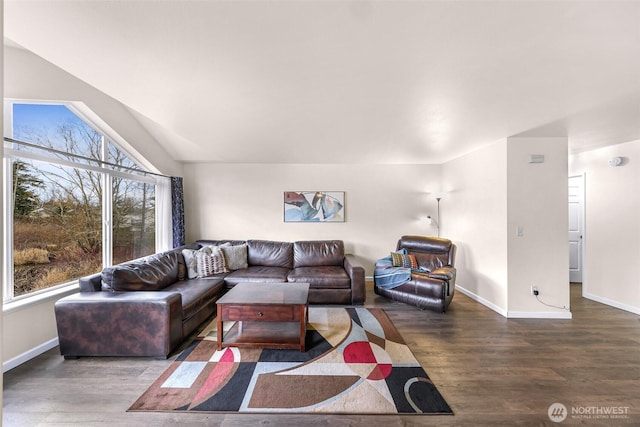 living room with lofted ceiling, wood finished floors, and baseboards