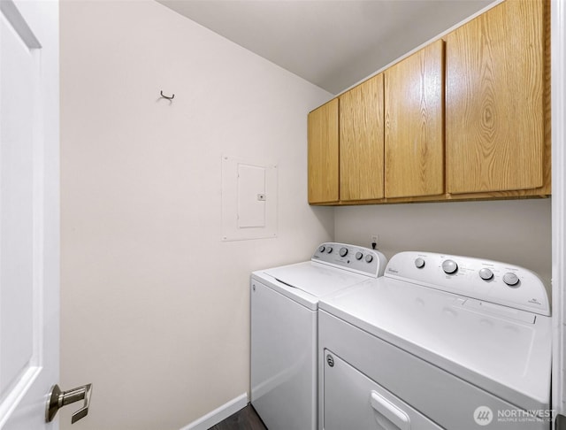 laundry room featuring electric panel, cabinet space, baseboards, and washing machine and clothes dryer