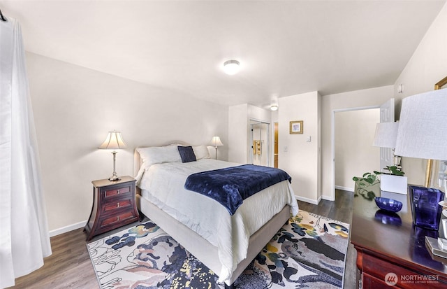 bedroom featuring wood finished floors and baseboards