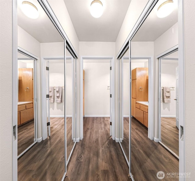 hall with dark wood finished floors and baseboards