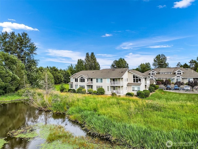 back of property featuring a water view