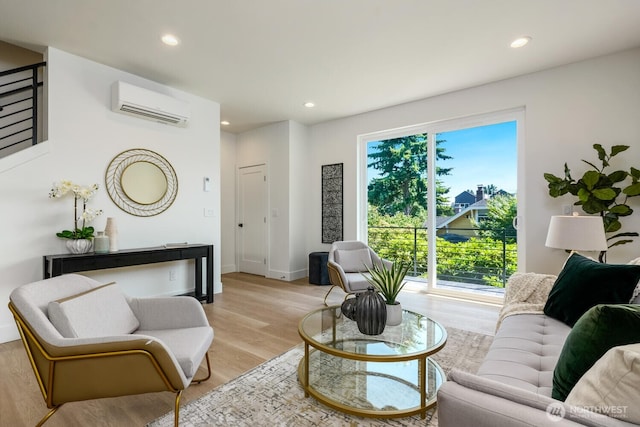 living room with an AC wall unit, light wood finished floors, and recessed lighting