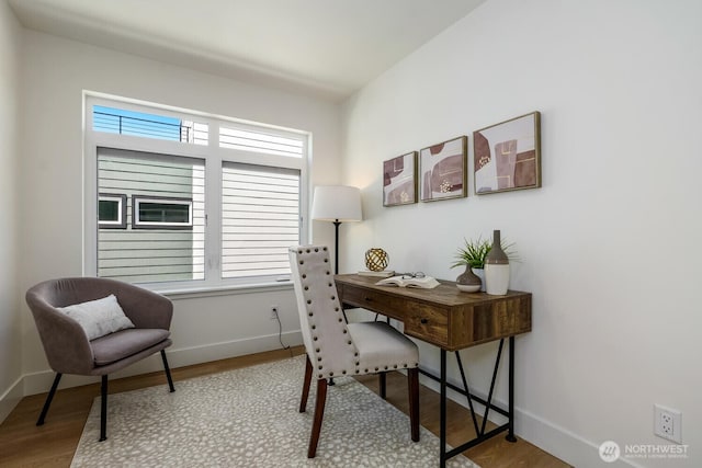 office area featuring wood finished floors, a wealth of natural light, and baseboards