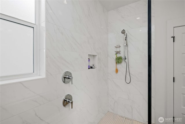 bathroom with a tile shower