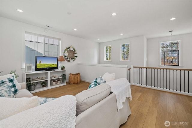 living room featuring recessed lighting, plenty of natural light, and wood finished floors