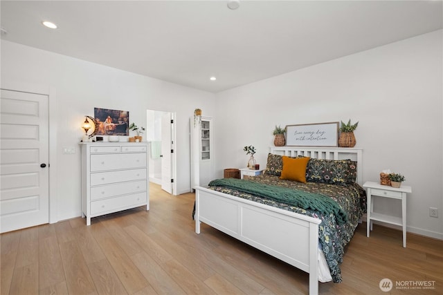 bedroom featuring baseboards, wood finished floors, and recessed lighting