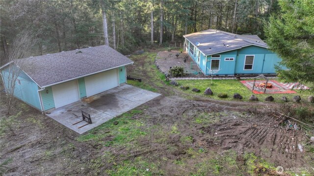 drone / aerial view with a wooded view