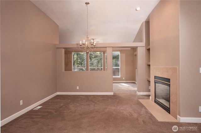 unfurnished living room featuring lofted ceiling, carpet flooring, baseboards, a chandelier, and a tile fireplace