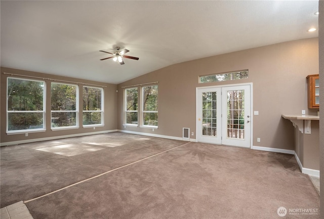 unfurnished living room featuring vaulted ceiling, carpet flooring, a ceiling fan, and baseboards