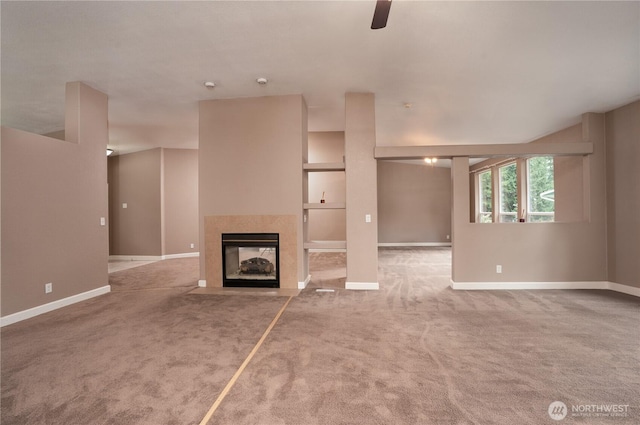 unfurnished living room with baseboards, carpet, ceiling fan, and a fireplace