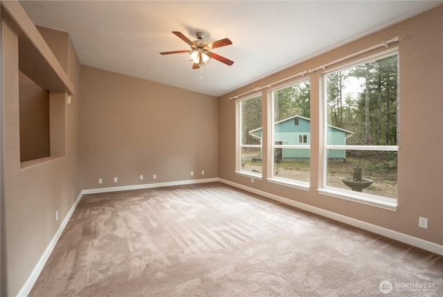 spare room featuring a ceiling fan, baseboards, and carpet floors