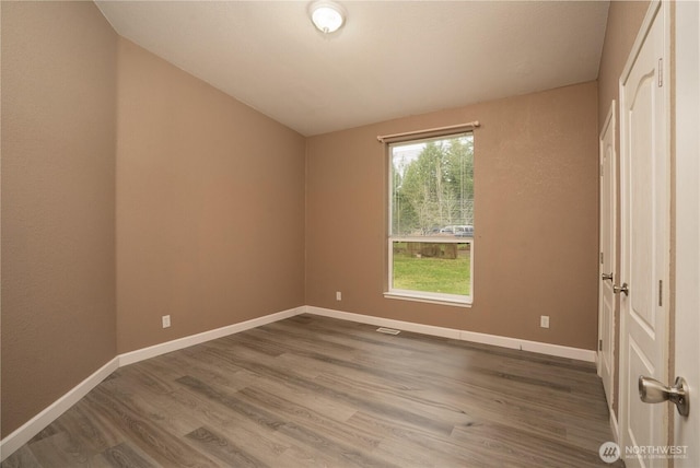 interior space with wood finished floors and baseboards