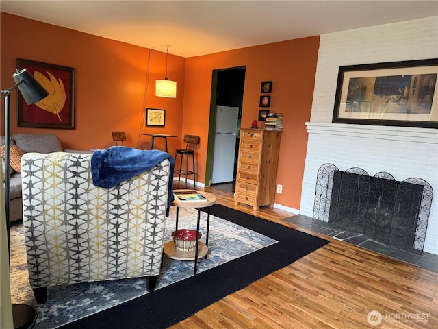 living room with baseboards and wood finished floors