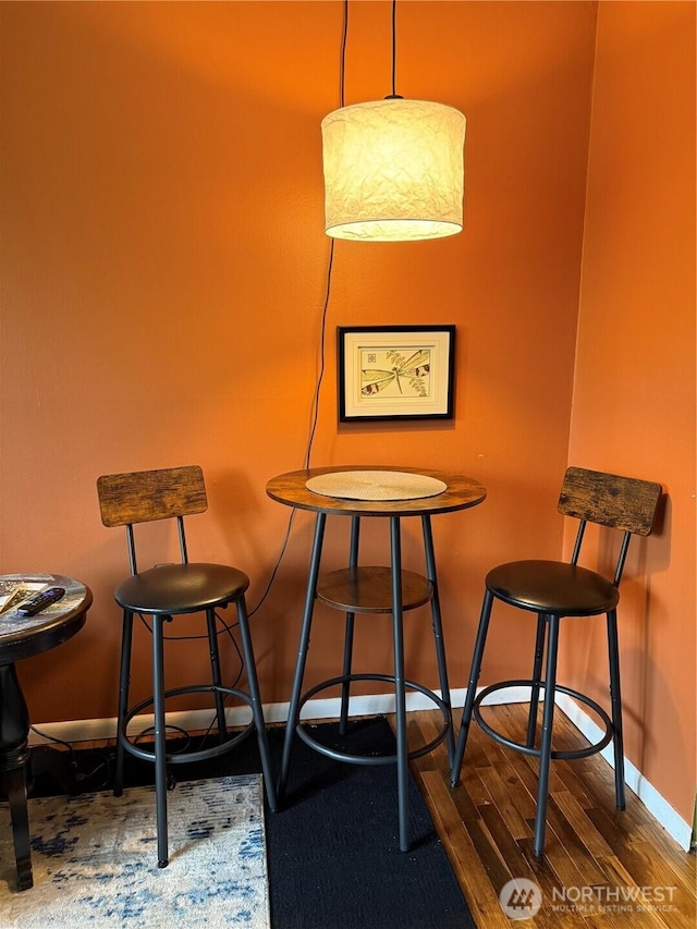 dining room featuring baseboards and wood finished floors