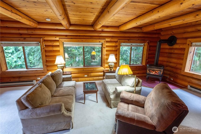 living area with a wood stove, plenty of natural light, a baseboard heating unit, and beamed ceiling