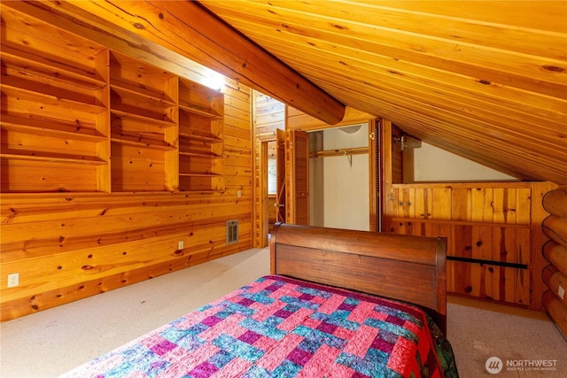 bedroom with lofted ceiling, wood walls, and carpet