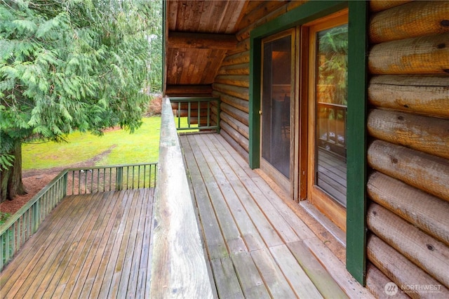 wooden deck featuring a lawn