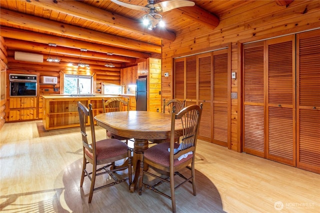 dining space featuring wood ceiling, light wood finished floors, and beam ceiling