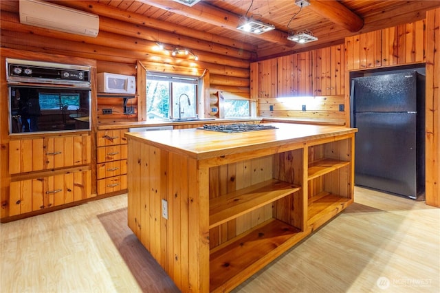 kitchen featuring a wall unit AC, light wood-style flooring, butcher block countertops, wood ceiling, and black appliances