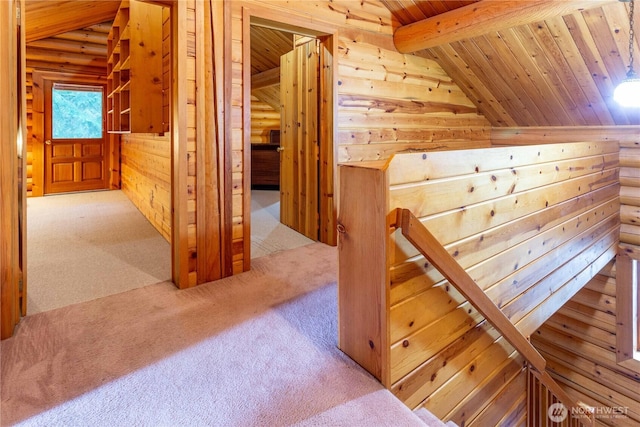 additional living space featuring vaulted ceiling with beams, wood ceiling, and carpet flooring