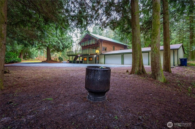 view of front of house featuring a garage and log siding