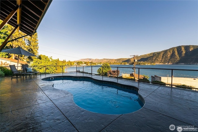 pool with a patio and a mountain view