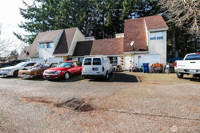 view of front of property featuring roof with shingles