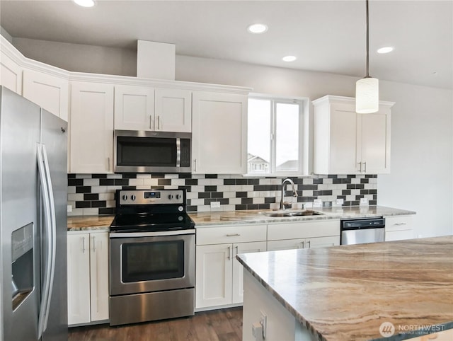 kitchen with tasteful backsplash, recessed lighting, appliances with stainless steel finishes, white cabinetry, and a sink