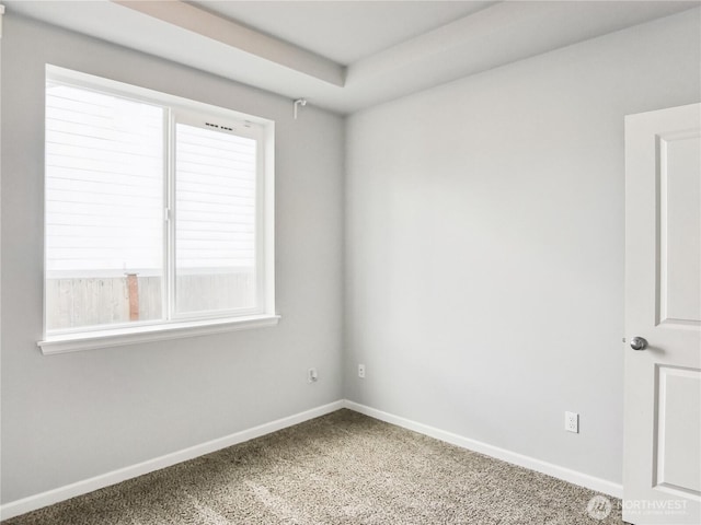 carpeted empty room with baseboards