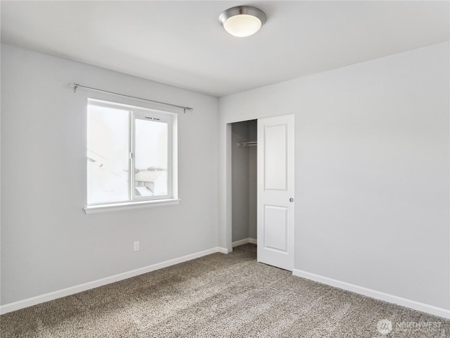 unfurnished bedroom featuring a closet, baseboards, and light colored carpet