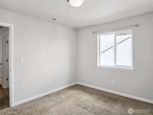 empty room with visible vents, baseboards, and carpet floors