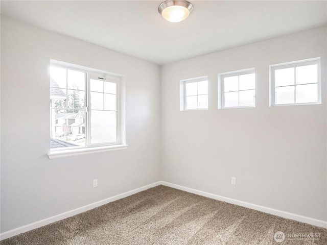 carpeted spare room with baseboards