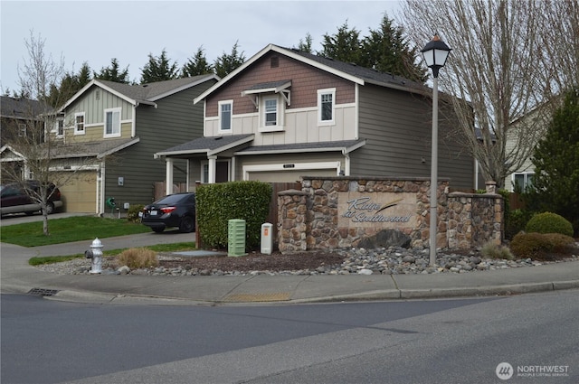 view of front of home with board and batten siding, concrete driveway, and a garage