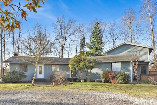 view of front of home featuring entry steps, a hot tub, and a front lawn