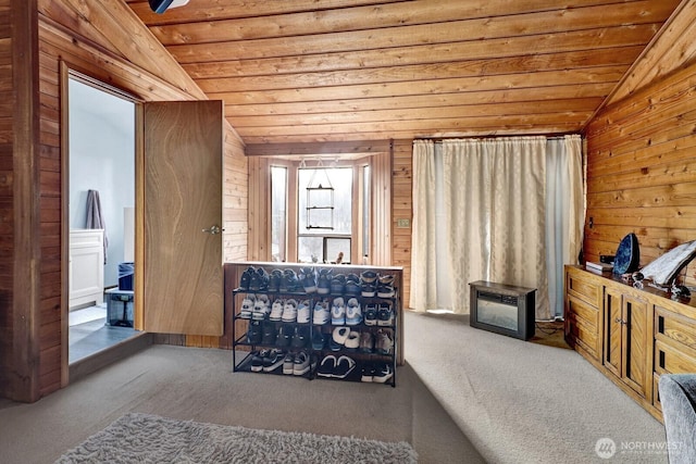 bedroom featuring vaulted ceiling, wood walls, carpet flooring, and wood ceiling