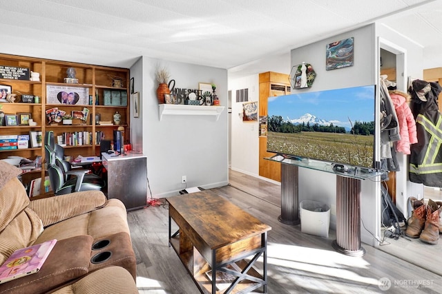 living area with wood finished floors and baseboards