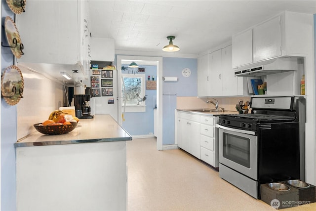 kitchen featuring a sink, light countertops, white cabinets, under cabinet range hood, and gas range