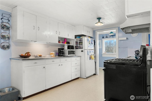 kitchen with under cabinet range hood, light floors, white appliances, and white cabinets