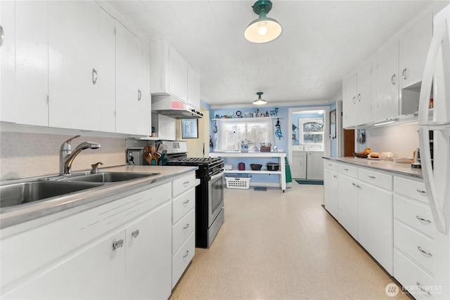 kitchen with stainless steel gas stove, washer and clothes dryer, a sink, light floors, and extractor fan