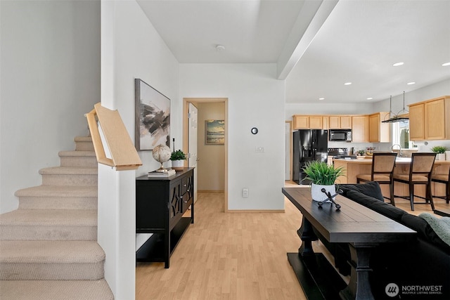 interior space with stairs, recessed lighting, baseboards, and light wood-style floors