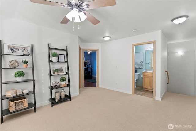 interior space featuring carpet, baseboards, and ensuite bathroom